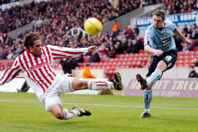Frazer Richardson crosses as Stoke City's Darel Russell attempts to block.