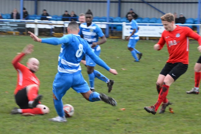 Sam Nelson aims a big kick at the ball and had to evade a Parkgate challenge.