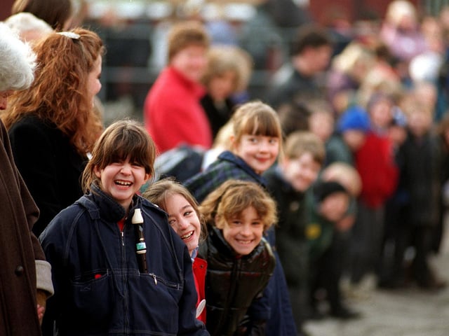 Pupils Gemma Layton, Amelia Hussain, Francesca Shaw and Rosemary Hallatt form part of a human chain around Cookridge Primary School as part of a demonstration against its planned closure.