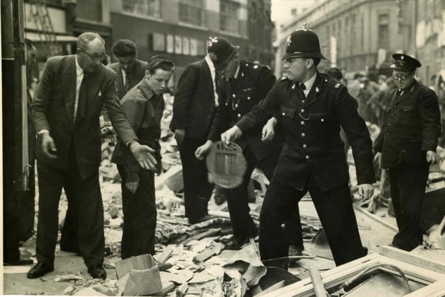 Civilians join the police in clearing debris