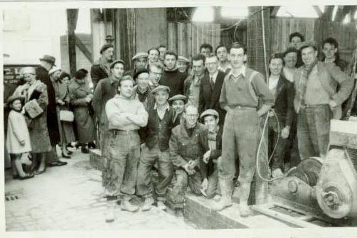 The construction crew in 1956 at Redman's Cafe. Photo by courtesy of Frank Metcalfe who is seen wearing a black jumper towards the centre on the photograph. He had been working in the building when it collapsed and said the foreman Alf Millership had warned everyone to get out of the building as it was moving.