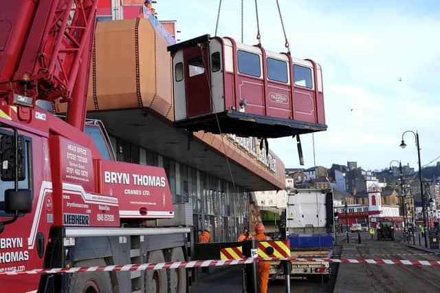 A crane lifts Scarborough tramway carriages away for major revamp.