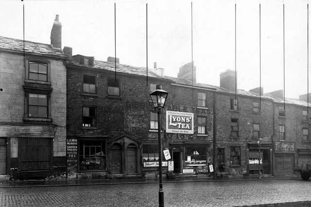 George Street in October 1947., Pictured are Holdswoth's coffee and cocoa house, L. Newman, paper bag manufacturer and G. Thompson, fruitier.