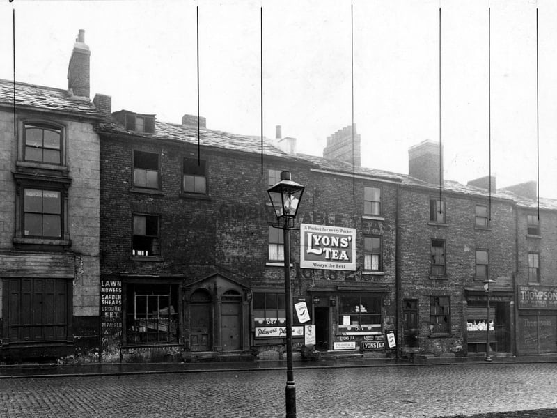 George Street in October 1947., Pictured are Holdswoth's coffee and cocoa house, L. Newman, paper bag manufacturer and G. Thompson, fruitier.