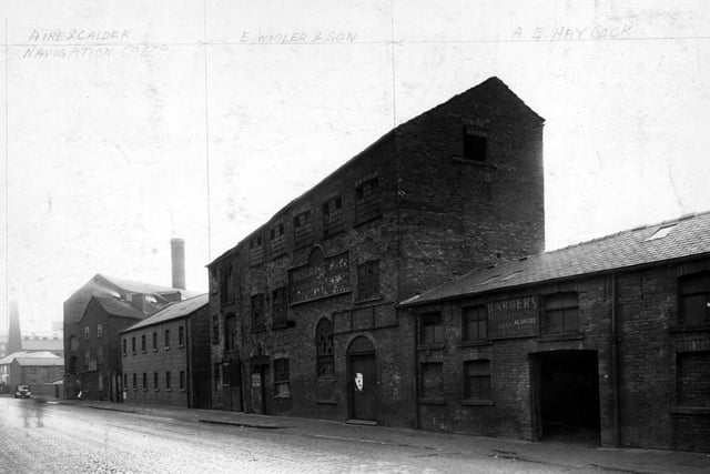 Mills and factories on East Street in November 1948, some of which are disused. The ones that aren't are the premises of 'Aire and Calder Navigation Co. Ltd.', 'E.Wooler and Son', 'A.E. Haycock'.