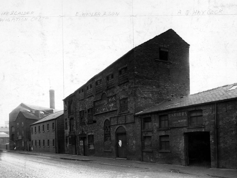 Mills and factories on East Street in November 1948, some of which are disused. The ones that aren't are the premises of 'Aire and Calder Navigation Co. Ltd.', 'E.Wooler and Son', 'A.E. Haycock'.
