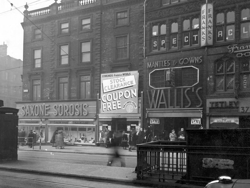 The west side of Briggate in January 1947, with the junction with Boar Lane on the left. In the foreground is a police telephone box and the entrance to the Gentlemen's public toilets.