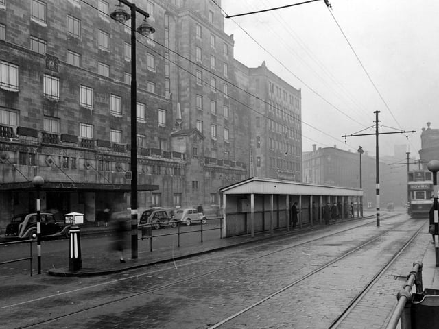 Leeds City Tramways Shelter outside the Queens Hotel on a grey December day in 1946. The photograph looks towards Wellington Street and the Majestic Cinema past the News Theatre and City Station.