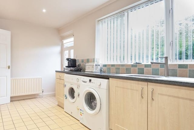This well equipped utility room adds to the many facilities within the kitchen.