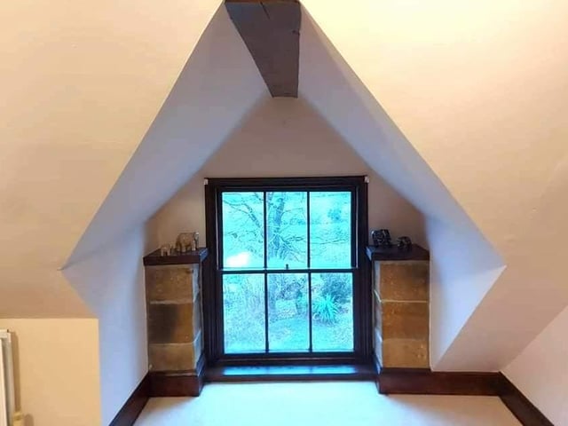 Look out over lovely countryside from this unique window setting.