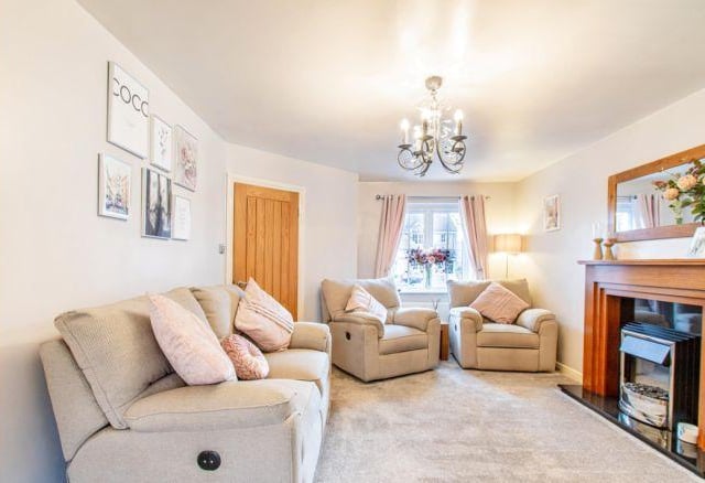 To the front of the house is the cosy and comfortable living area. Its focal point is the warm fireplace and it has double oak doors leading into the open plan living space.