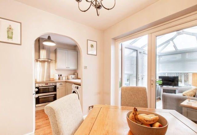 An archway leads into the dining area, which in turn has double doors leading into the conservatory.