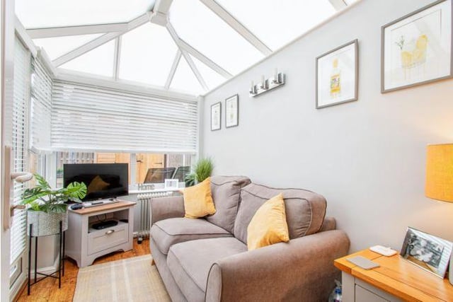 The small conservatory is a great addition to the house. It comfortably fits a large sofa, and the current owners have added a TV to make it the perfect nook to relax in.