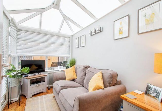 The small conservatory is a great addition to the house. It comfortably fits a large sofa, and the current owners have added a TV to make it the perfect nook to relax in.