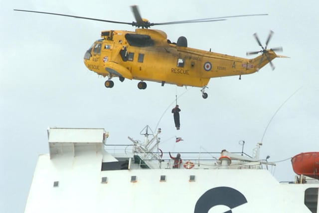 A sea rescue helicopter lowering salvage experts onto the stricken ferry