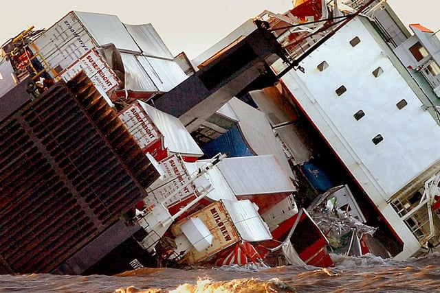 Stranded - the waves lap the containers which were spilling out into the sea