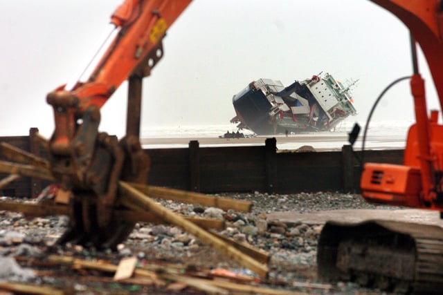 Aside from the salvage operation to move the vessel, debris which washed ashore had to be shifted, as this photo shows