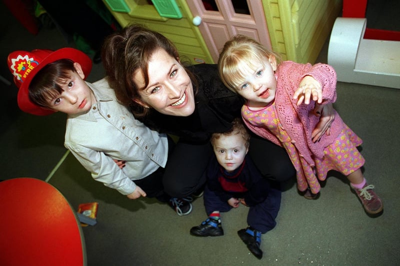 Actress Kazia Pelka, nurse Maggie Bolton from TV's Heartbeat, was at the NCH Action For Children's Broom Hill Family Centre in Harehills to receive a £53,000 cheque on behalf of the charity from Marks and Spencer. She is pictured with three of the children at the Centre, from left, Dillon Bown, Ryan Slattery and Zoe Bown.