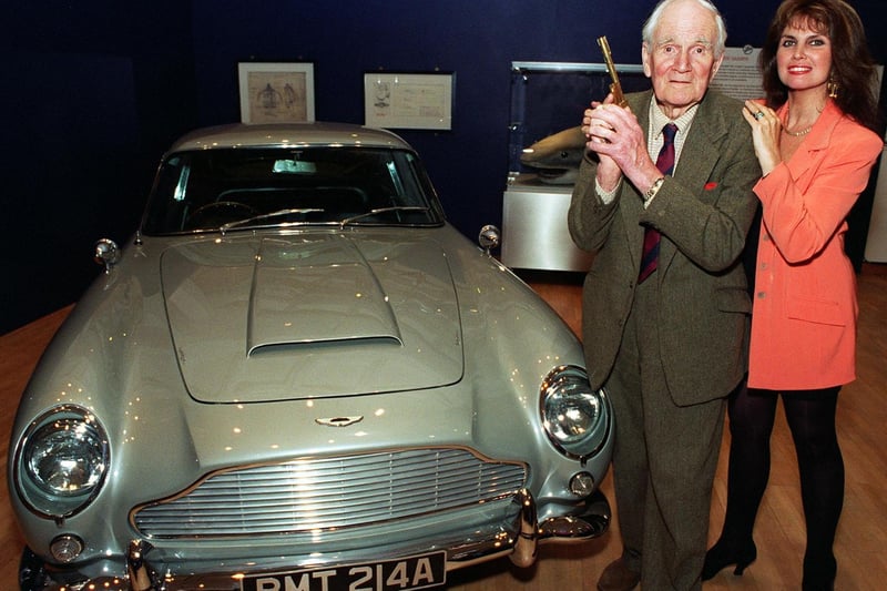 May 1997 and actor Desmond Llewelyn, Q in the James Bond films, holds the original golden gun with Caroline Munro one of the Bond girls alongside an Aston Martin. The pair were at the Royal Armouries in Leeds to promote a 007 exhibition.