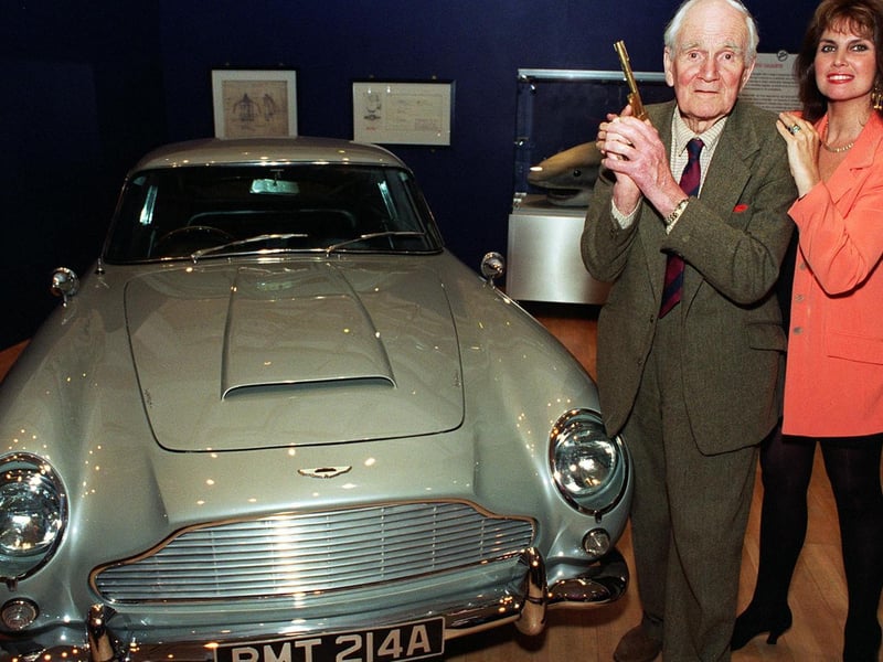 May 1997 and actor Desmond Llewelyn, Q in the James Bond films, holds the original golden gun with Caroline Munro one of the Bond girls alongside an Aston Martin. The pair were at the Royal Armouries in Leeds to promote a 007 exhibition.