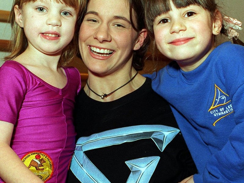 This is Kerryn Sampey, champion of the Gladiators Ashes series in 1995. She is pictured giving two young gymnasts - Alice Wilkins (left) and Angela Shanks - a lift at Leeds Carnegie College in February 1996.