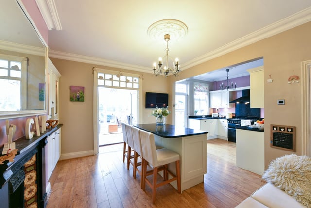 An exceptionally light and bright interior with a kitchen island and breakfast bar.
