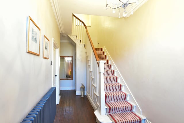 The spindle staircase leads up to the first and second floors of the property.