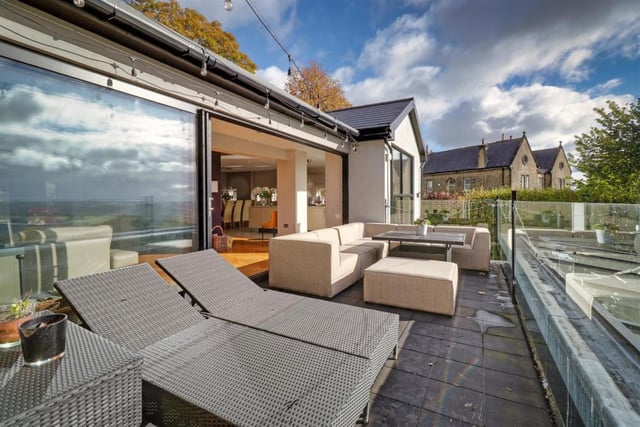 This £1,450,000 property in Rawdon is a modern masterpiece. Located in Larkfield Road, the house is set in ground of approximately 3/4 of an acre and boasts breath-taking views. Accessed through electric gates off a private driveway, the house has a large living/dining/kitchen, alongside a spacious family room with a bar, and a cinema room.