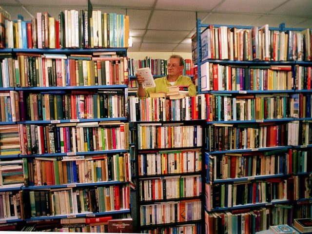 Graham Draisey with the large selection of books at the OXFAM Bookshop on Otley Road.