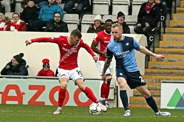 Morecambe's Shane McLoughlin gets away from Jack Grimmer