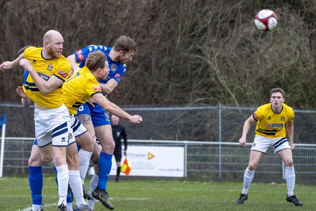Centre-half Spencer Clarke shows determination to get to the ball first. Picture Scott Merrylees.