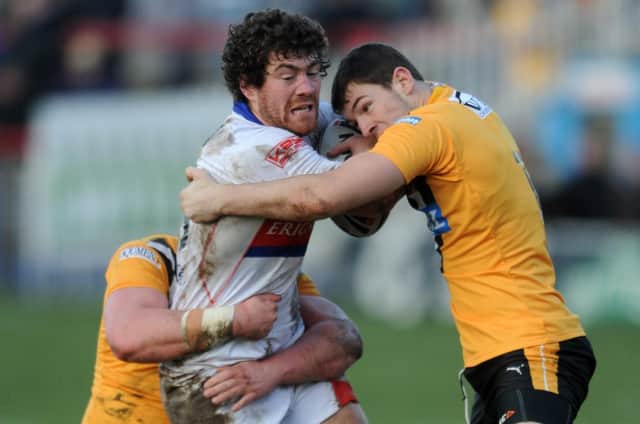 A young Daryl Clark gets to grips with then Wakefield Trinity Wildcats player Kyle Amor in the two local rivals' pre-season match from January, 2012. Wakefield held the bragging rights on this occasion, winning 40-20.