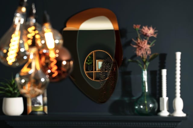 Lights from Andy Thornton in Elland with scessories including a vintage mirror, candles and glass vase with flowers
