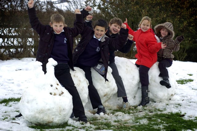 It's snow joke: Pupils from Seton School, Staithes, sit on their caterpillar snow creation.