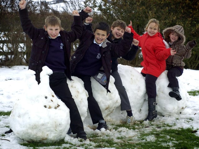 It's snow joke: Pupils from Seton School, Staithes, sit on their caterpillar snow creation.