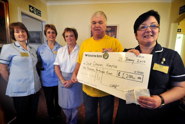 Dennis Booth presents Shirley Schofield a cheque after doing the Great North Run, along with other staff from St Catherine's Hospice in Whitby; Heather Hird, Karen Sewell and Dawn Collinson.