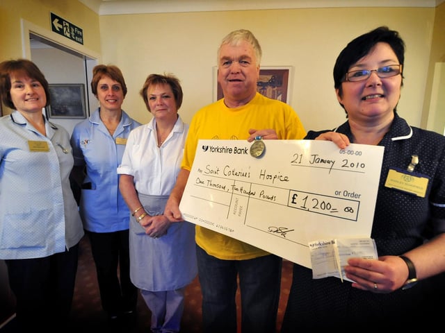 Dennis Booth presents Shirley Schofield a cheque after doing the Great North Run, along with other staff from St Catherine's Hospice in Whitby; Heather Hird, Karen Sewell and Dawn Collinson.