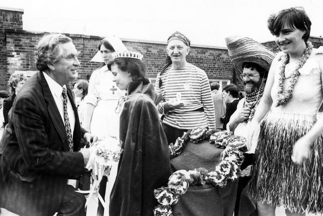 Gipton Gala in July 1986. Denis Healey MP crowns Gala Queen Ann Marie Duffy watched by local people in fancy dress costumes. He went down on bended knee to present the Queen with a Silver cup. Her attendants, Princess Katie Manning and Prince Shane Bosomworth were also presented with a gift.