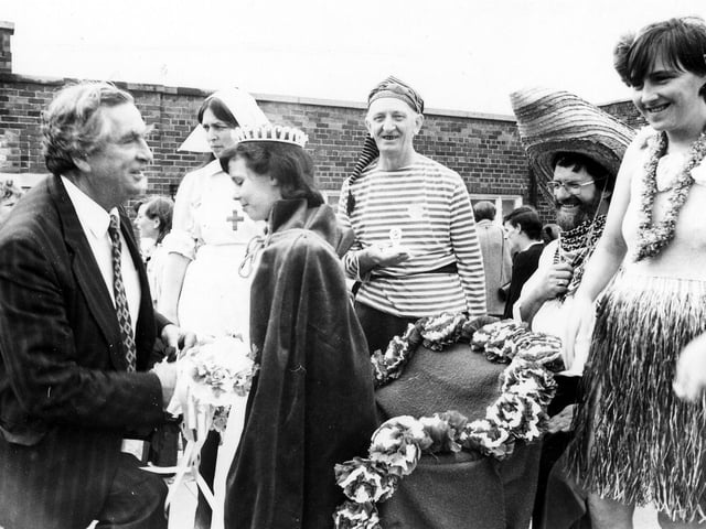 Gipton Gala in July 1986. Denis Healey MP crowns Gala Queen Ann Marie Duffy watched by local people in fancy dress costumes. He went down on bended knee to present the Queen with a Silver cup. Her attendants, Princess Katie Manning and Prince Shane Bosomworth were also presented with a gift.