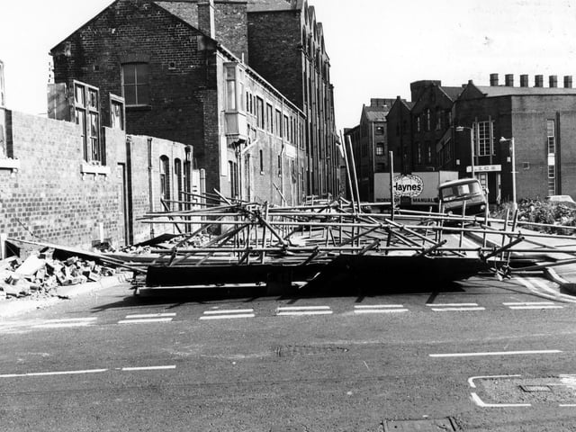 David Street looking from Manor Road in June 1986. On the left, demolition is taking place on David Street, blocking off the road in the process. On the right is a cleared area where St. Francis' R.C. Church and St. Joseph's R.C. Secondary School once stood. Behind this is a department of the Leeds Industrial Co-operative Society.