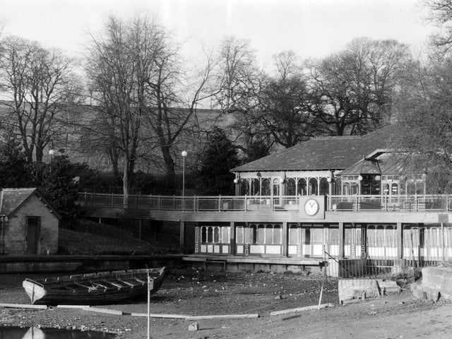 The Lakeside Café, possibly taken at the time that it was being converted into a café from the former boathouse. The edge of Waterloo Lake in front has been drained of water and a lone boat sits at the bottom.