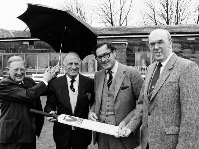 Sir Leonard Hutton went back to his cricket roots with Yorkshire president Viscount Montgarret to open the new clubhouse extension at Pudsey St. Lawrence. Pictured sheltering under an umbrella, from left are club president Richard Smith, Sir Leonard, Lord Mountgarret and club chairman Keith Moss.