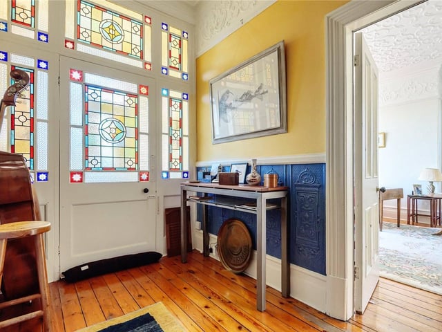 Enter into the hallway through the beautiful stained glass windowed doors.