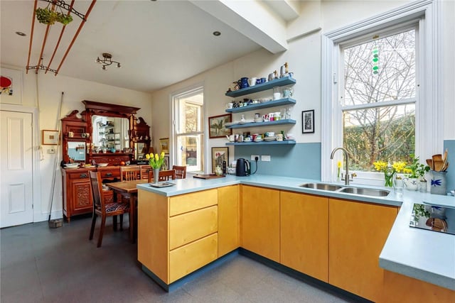 The extended dining kitchen is bright and wonderful, with yellow cabinets and windows overlooking the beautiful surroundings. There is also a utility space and downstairs W.C on this floor.