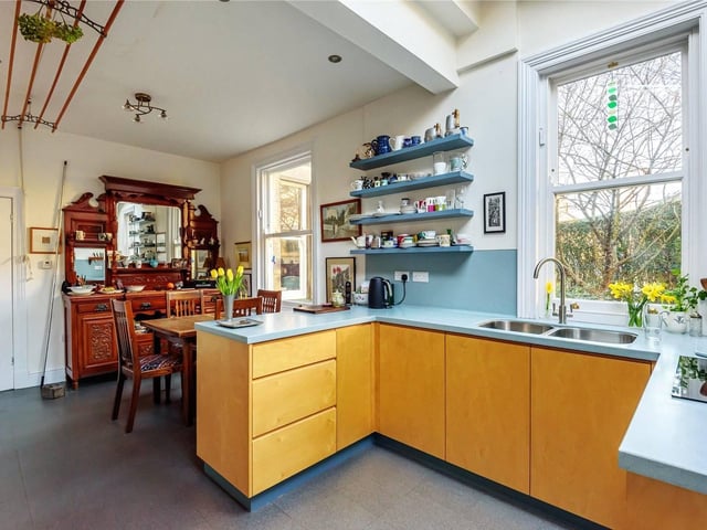 The extended dining kitchen is bright and wonderful, with yellow cabinets and windows overlooking the beautiful surroundings. There is also a utility space and downstairs W.C on this floor.