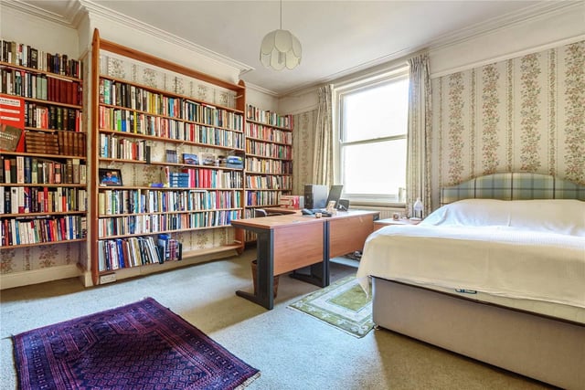 One of the other bedrooms, which currently houses plenty of books and a spare desk space.