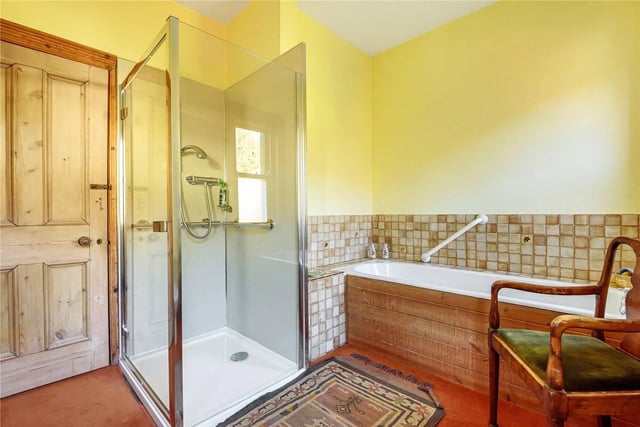 The family bathroom has a walk in shower and separate bath.