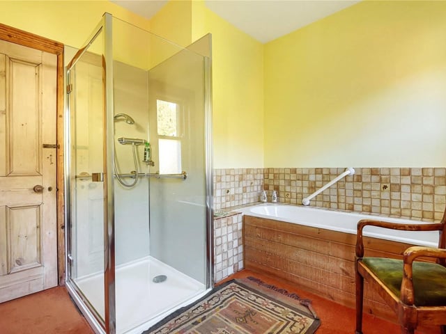The family bathroom has a walk in shower and separate bath.