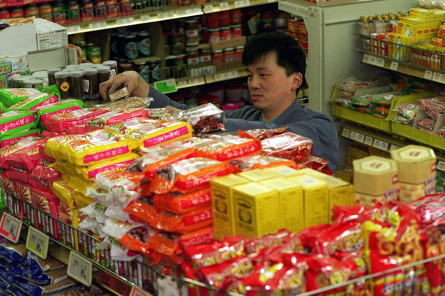 Derek Hoy of the Wing Lee Hong supermarket in Leeds stocks shelves as the store gets ready for the Chinese New Year.