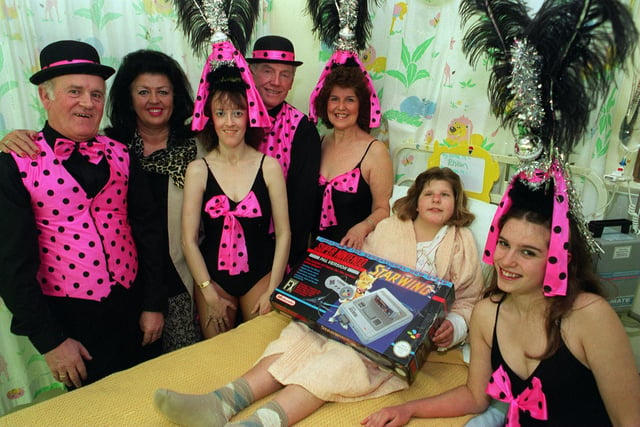 Showstoppers charity fundraising cabaret artists are pictured with Rhian Haskell in the LGI childrens surgical unit where they presented a Super Nintendo game. It replaced one that had been stolen from the ward. Pictured, from left, is Ken Eagleton, Jill Robinson MBE, Julie Lipscombe, Bernard Kelly, Margaret Bretherick and Julie Webster.